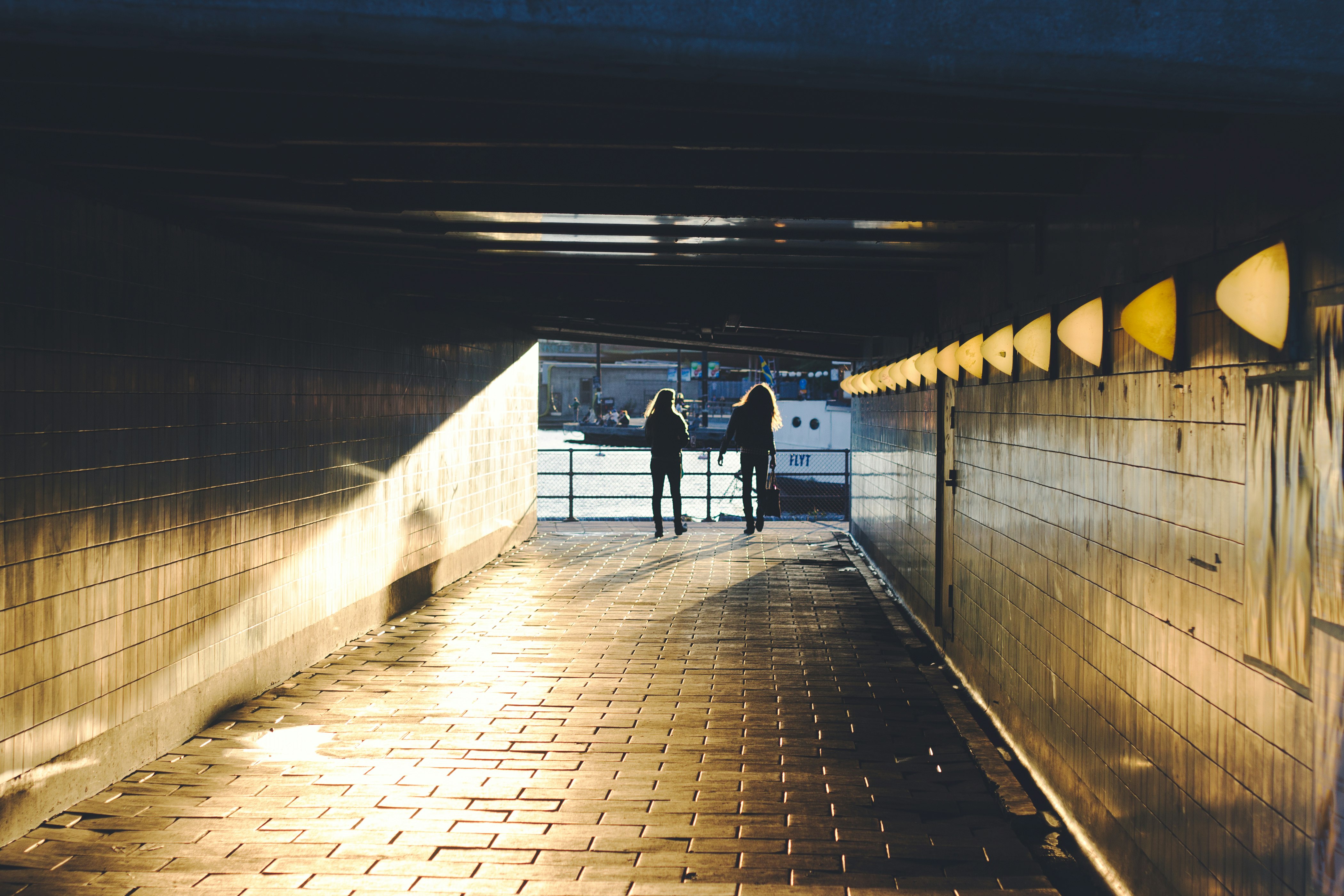 two person walking on hallway